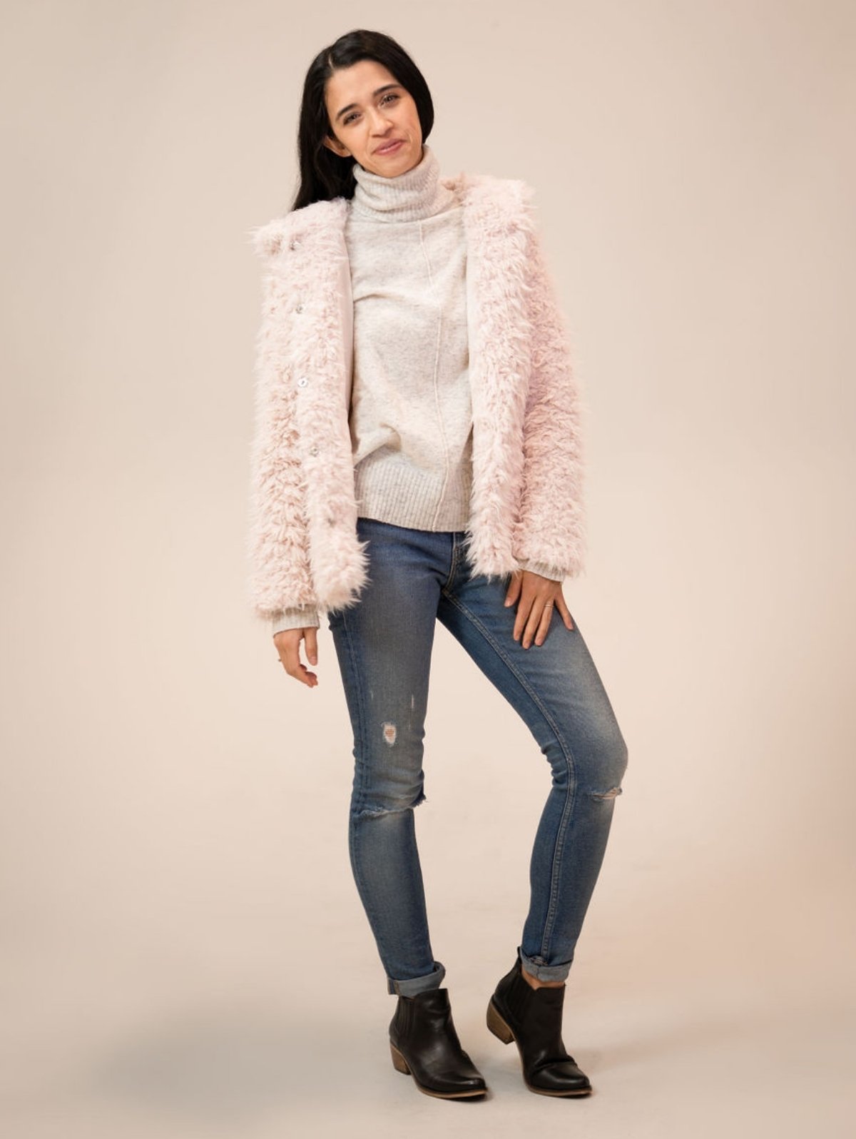 Ashley standing facing the camera wearing the Shine your Light coat