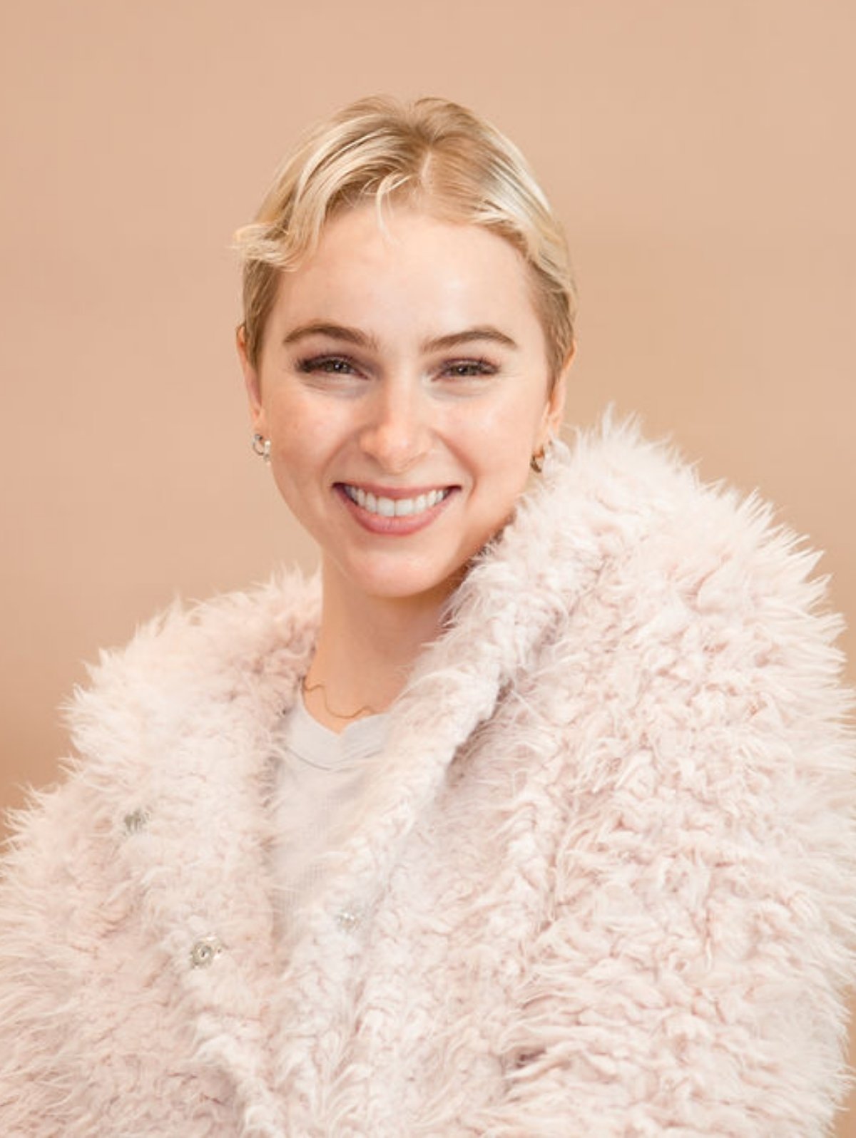 Julia smiling at the camera with the Shine your Light coat